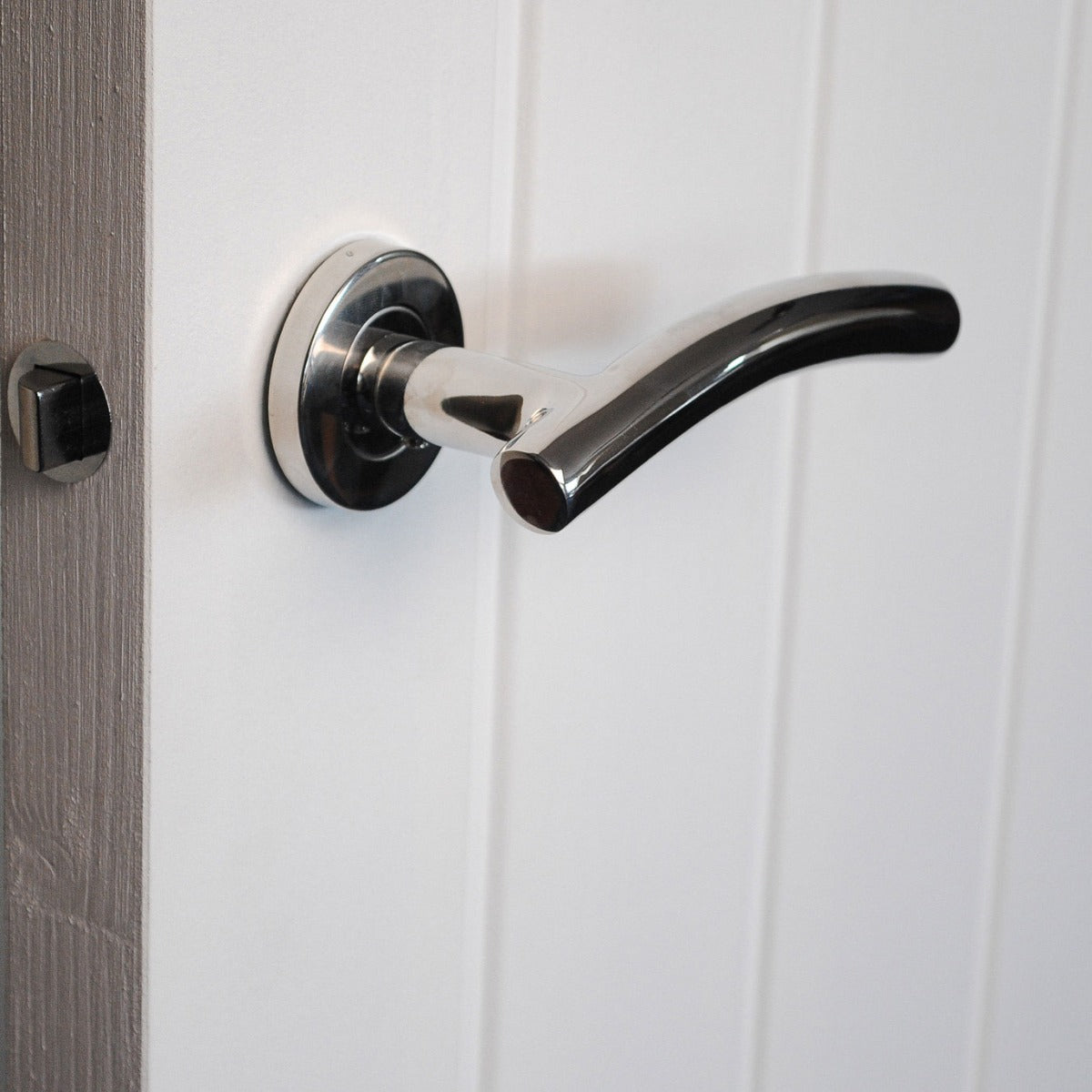 ViBE Curve Lever on Rose Door Handle in Polished Stainless Steel for Internal Doors